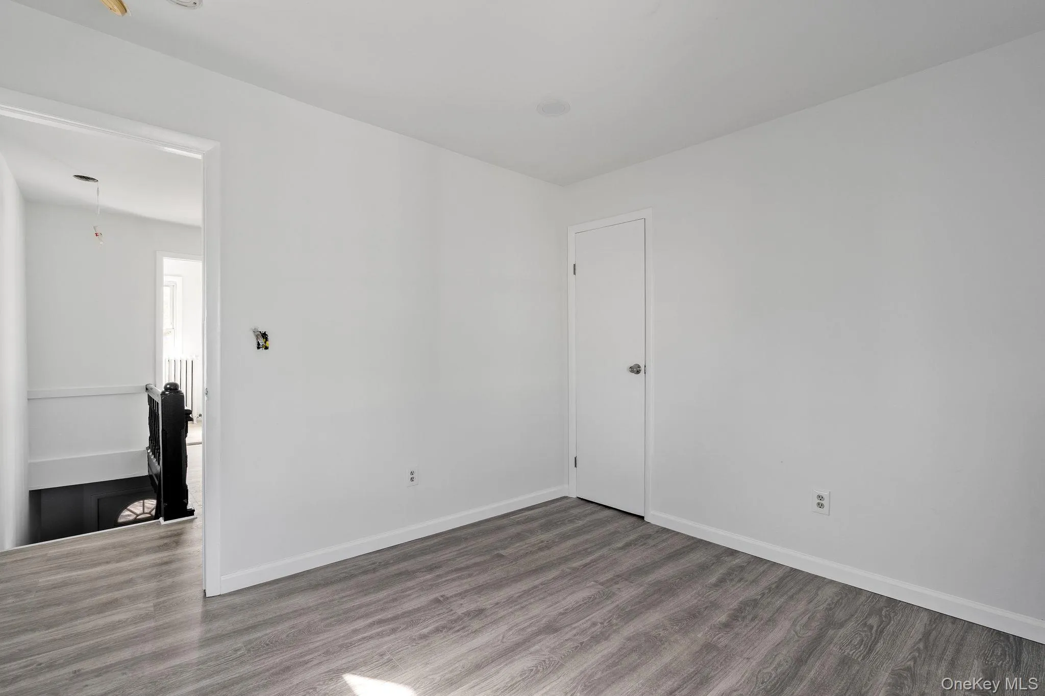 Empty room with wood finished floors and baseboards Empty room with wood finished floors and baseboards