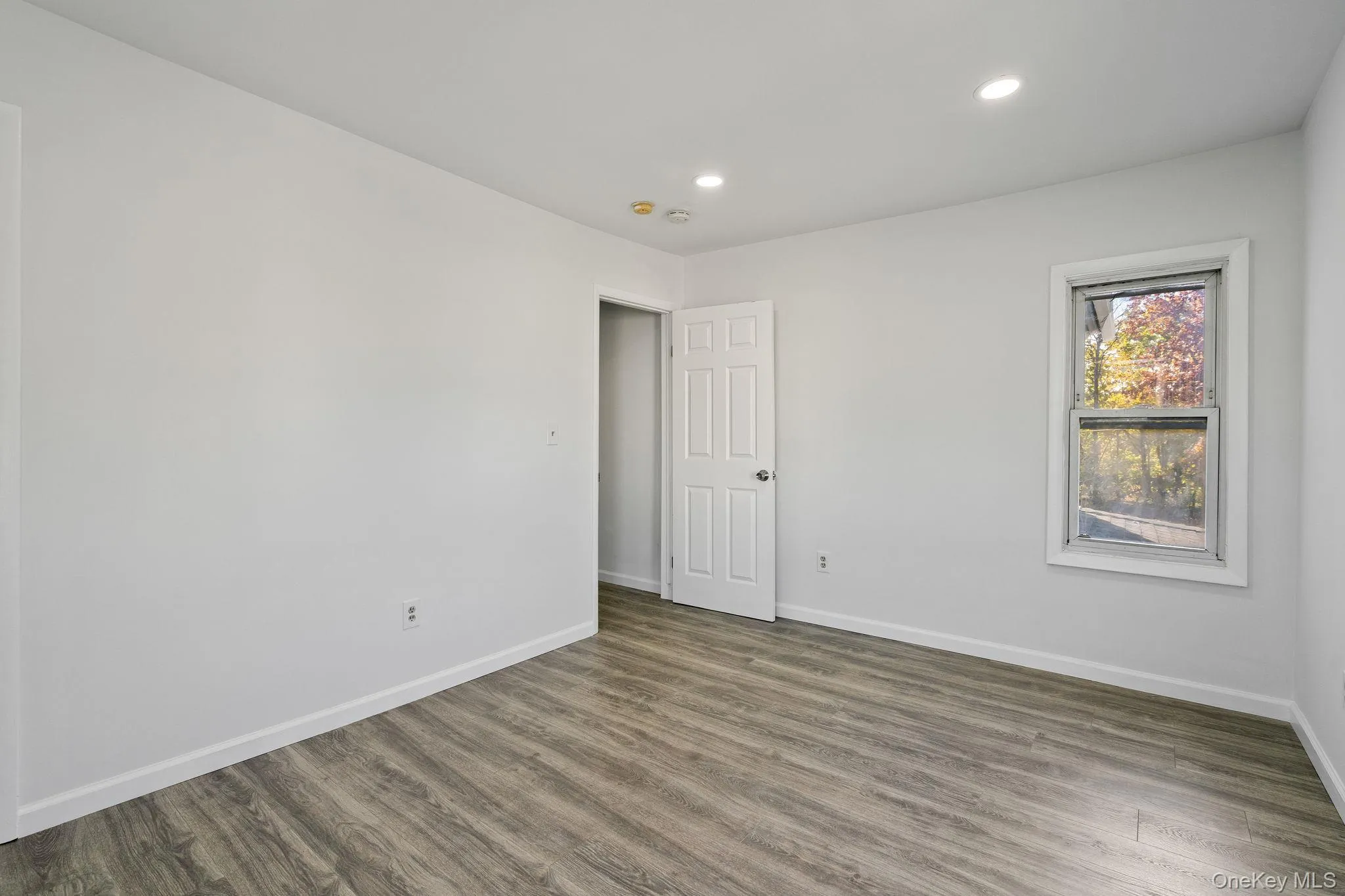 Spare room featuring recessed lighting and wood finished floors Spare room featuring recessed lighting and wood finished floors
