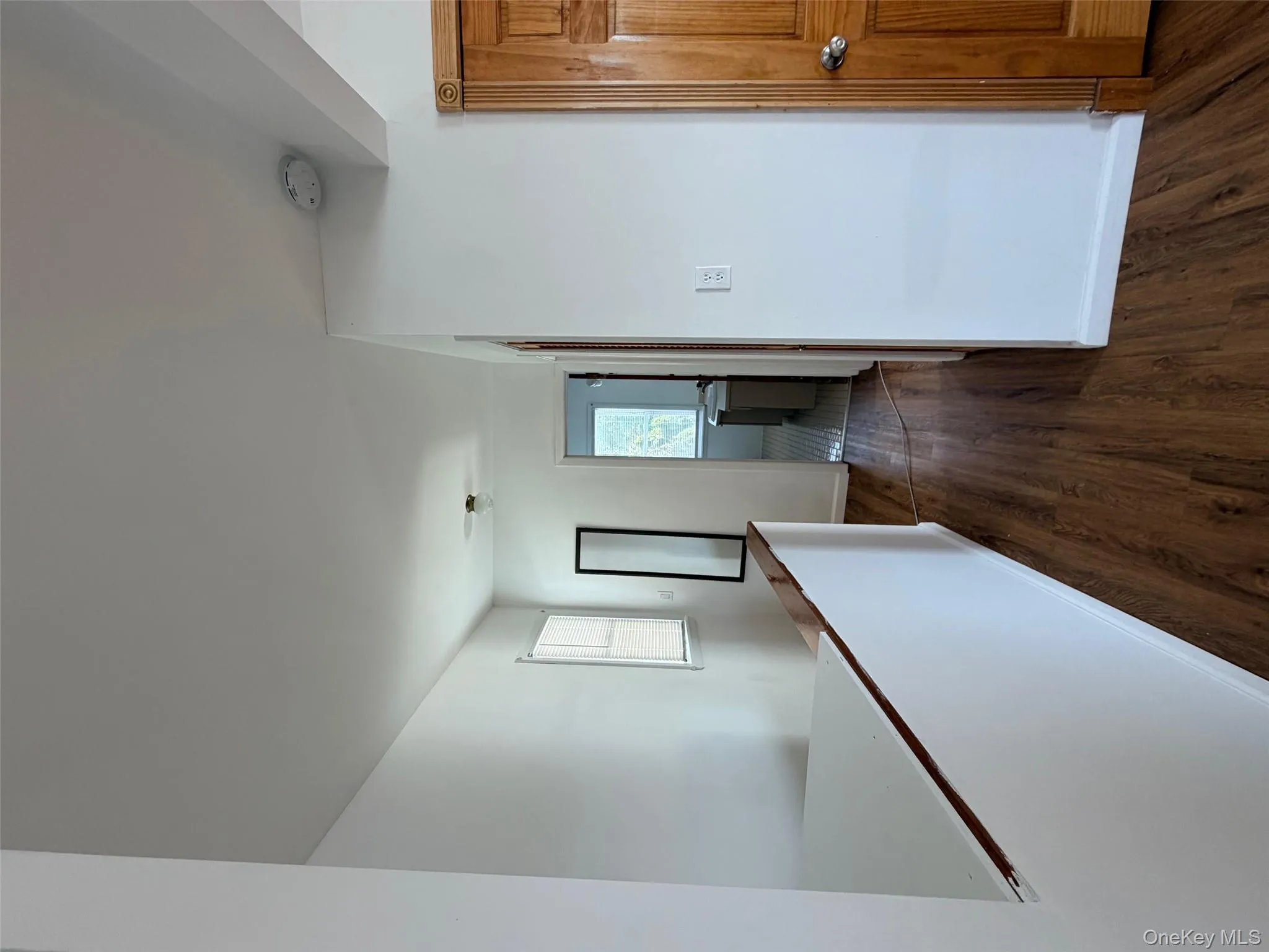 Corridor with dark wood-type flooring and an upstairs landing Corridor with dark wood-type flooring and an upstairs landing