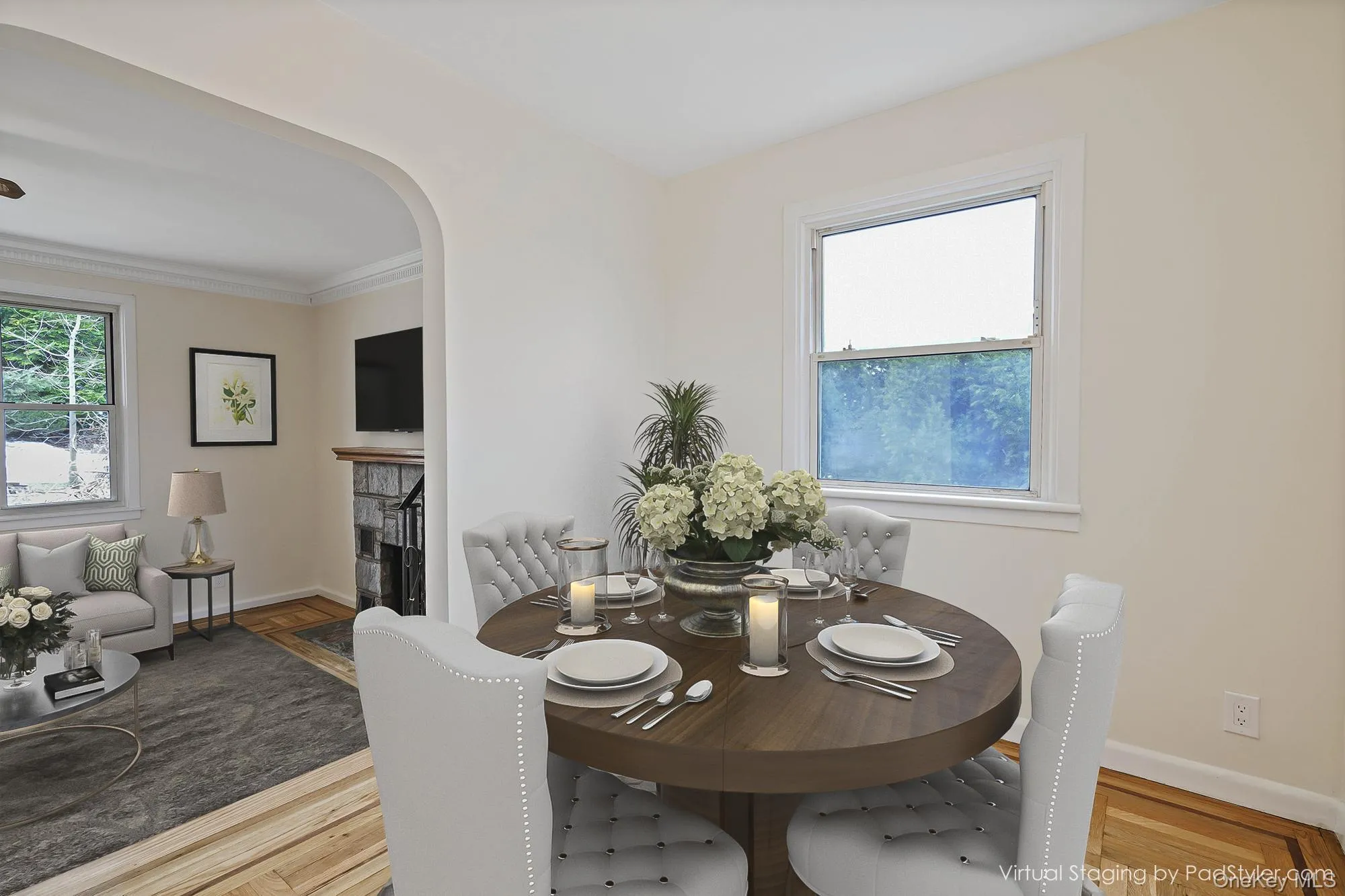 Virtually stagedDining space with a tile fireplace, plenty of natural light, arched walkways, parquet floors, and crown molding Virtually stagedDining space with a tile fireplace, plenty of natural light, arched walkways, parquet floors, and crown molding