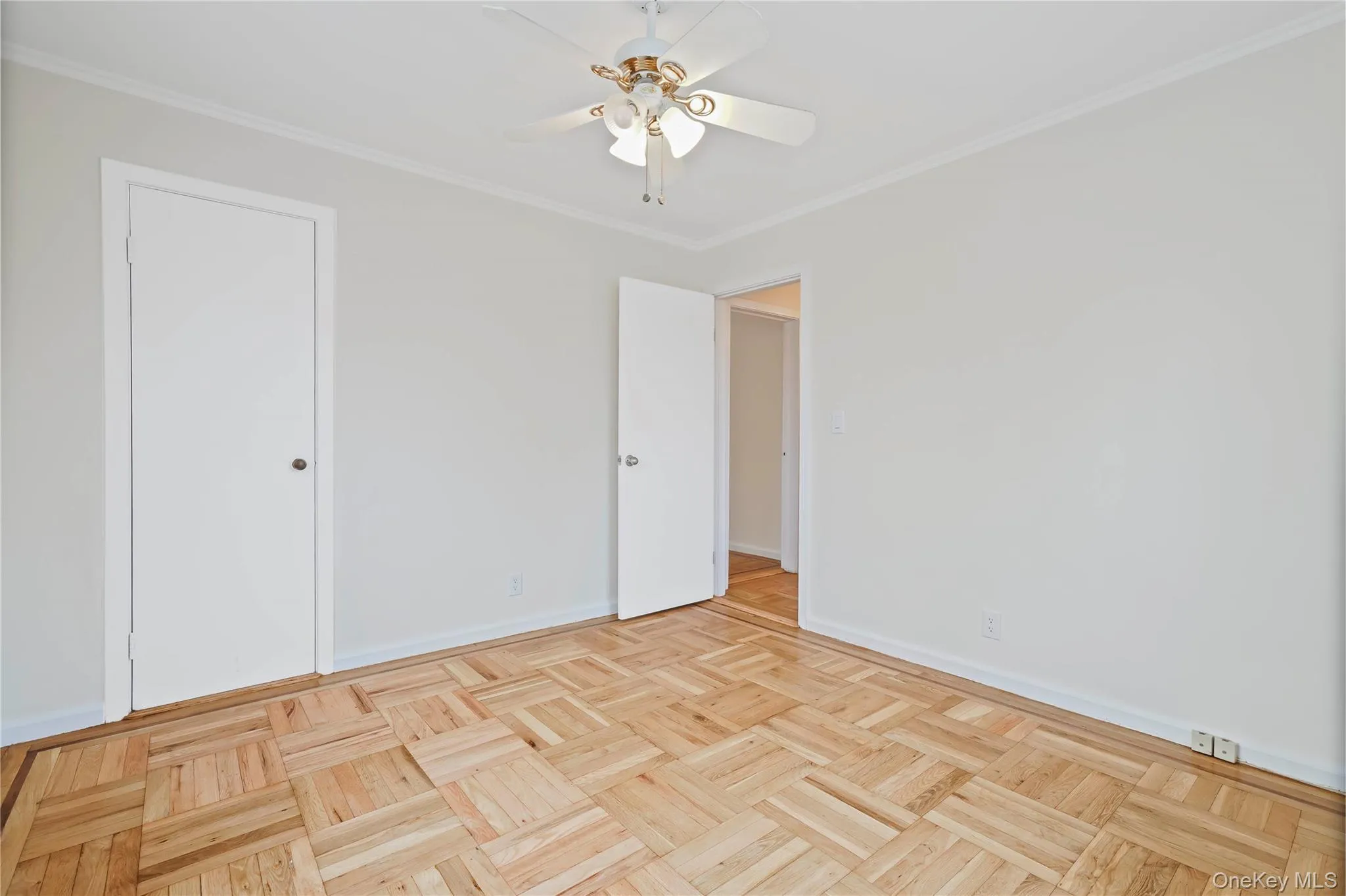 Unfurnished bedroom featuring crown molding and a ceiling fan Unfurnished bedroom featuring crown molding and a ceiling fan