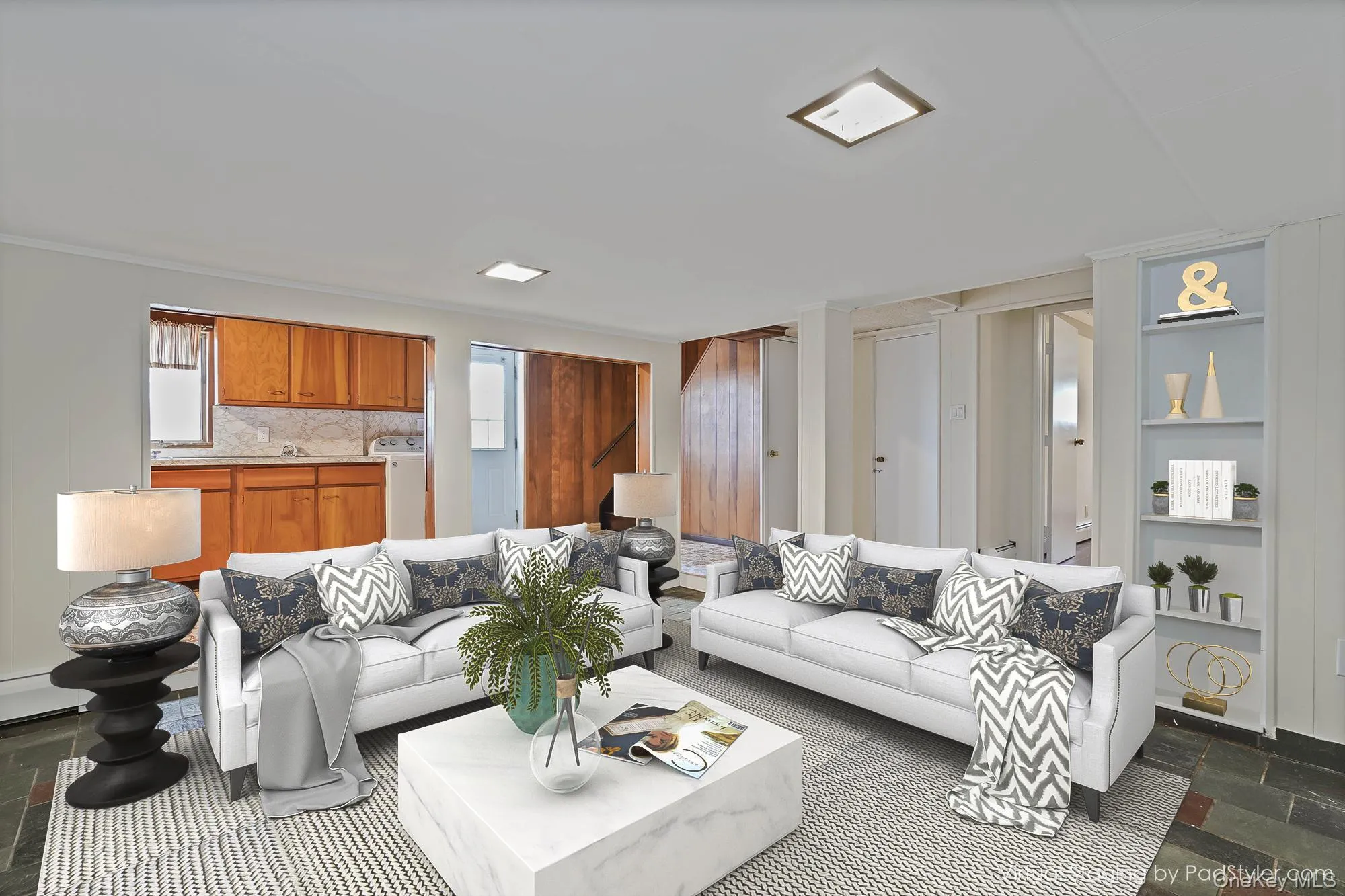 Virtually staged lower level family room featuring stone tile flooring, washer / dryer, and healthy amount of natural light. Door to yard. Virtually staged lower level family room featuring stone tile flooring, washer / dryer, and healthy amount of natural light. Door to yard.