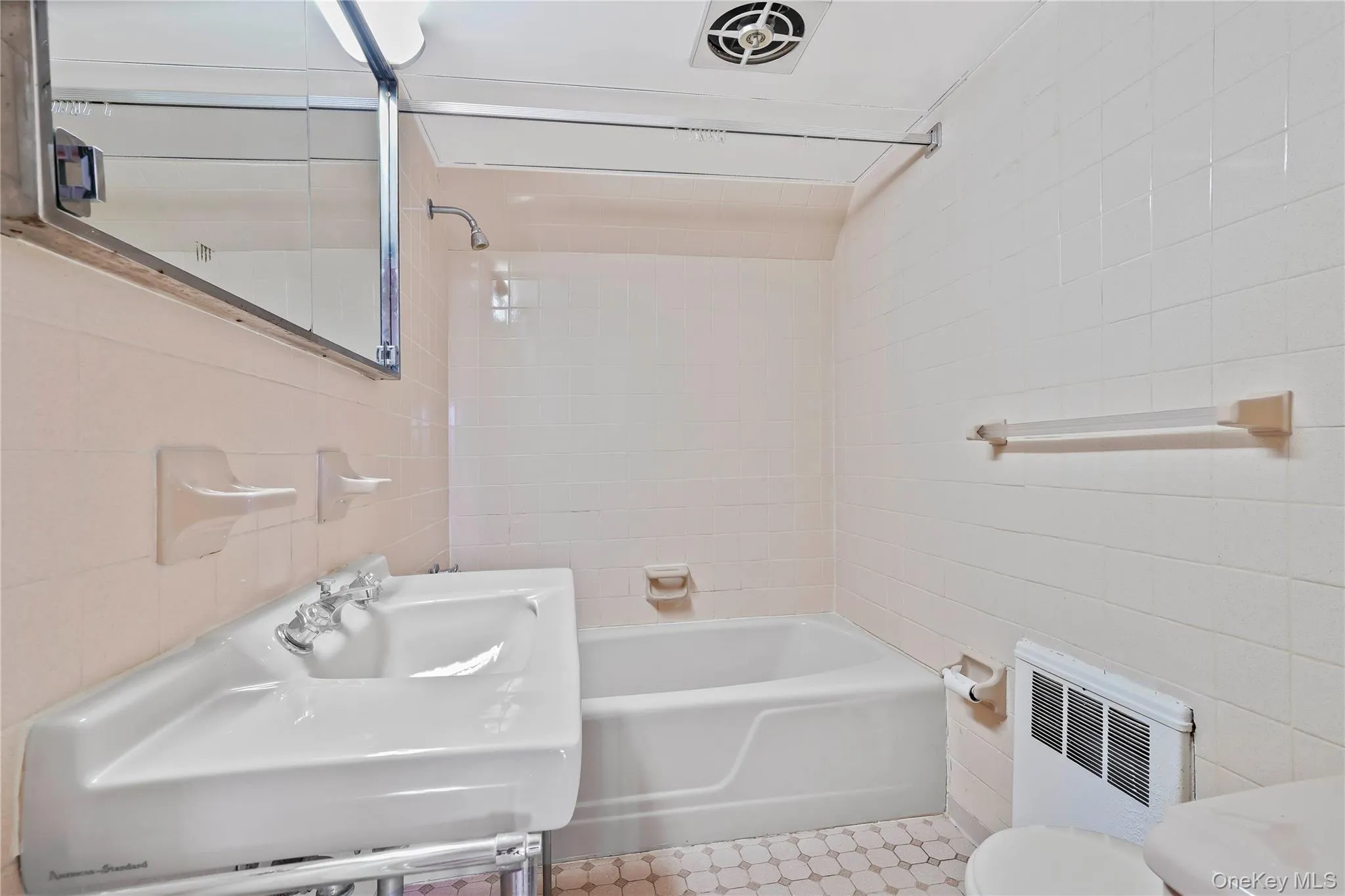 Bathroom with tile walls, shower / washtub combination, and vanity Bathroom with tile walls, shower / washtub combination, and vanity