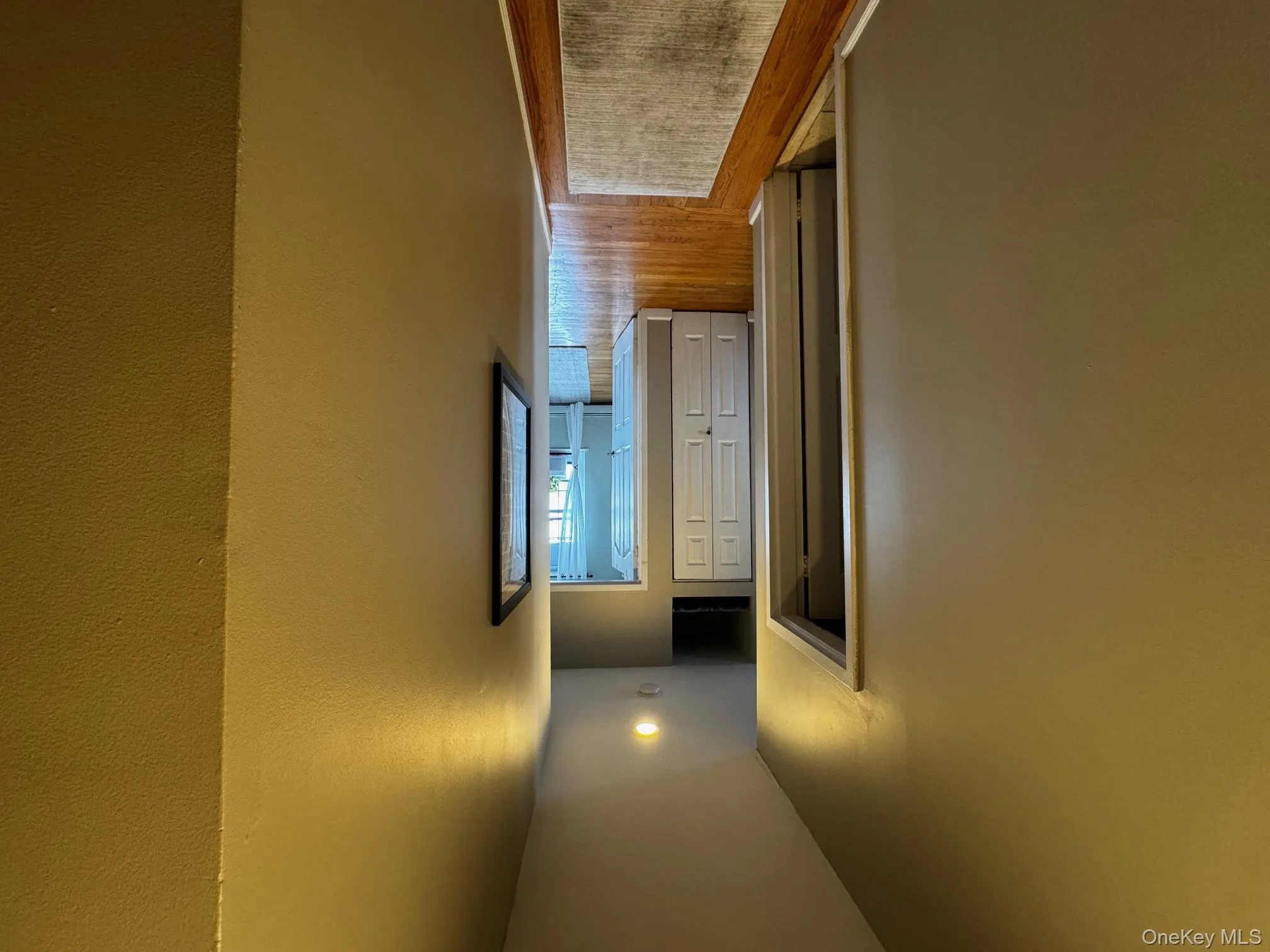 Corridor with light wood-style flooring and baseboards Corridor with light wood-style flooring and baseboards