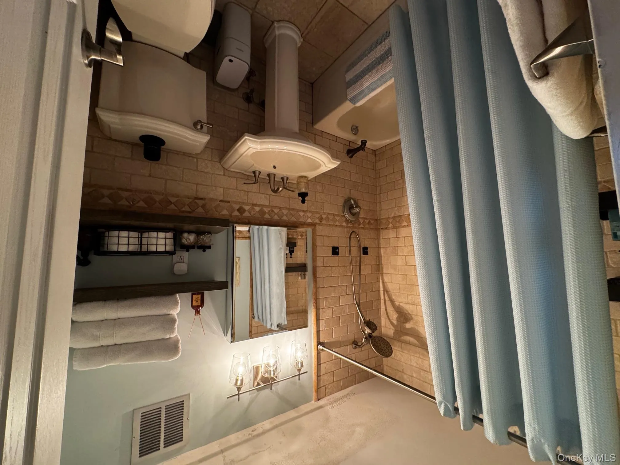 Full bath featuring shower / bath combination with curtain, visible vents, toilet, and tile patterned floors Full bath featuring shower / bath combination with curtain, visible vents, toilet, and tile patterned floors