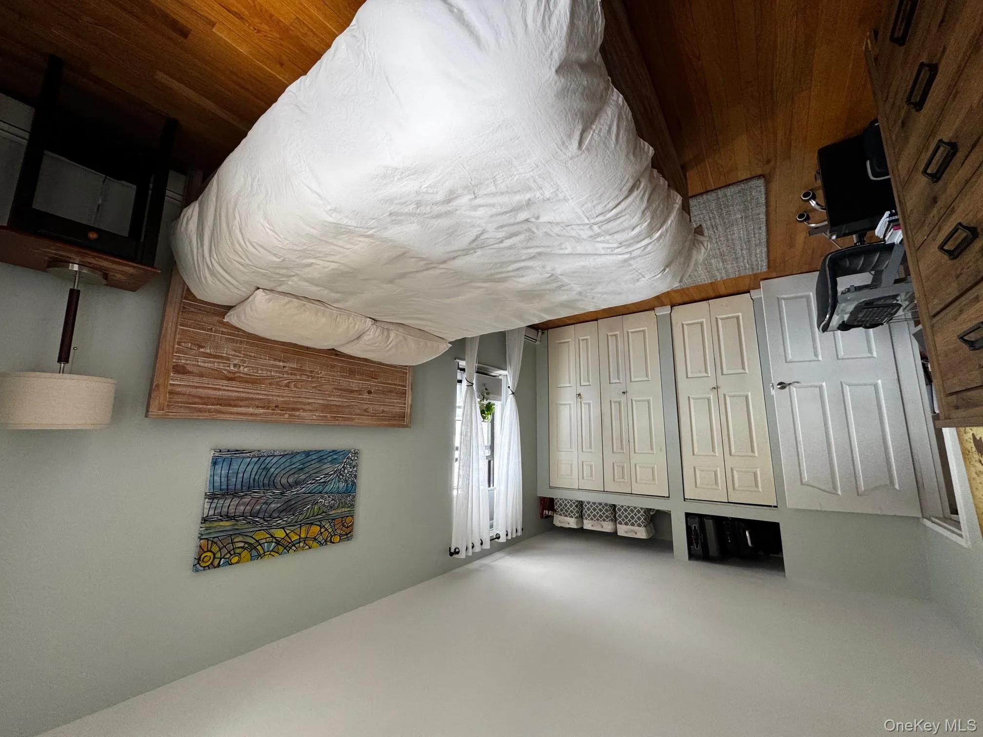 Bedroom featuring two closets and dark wood finished floors Bedroom featuring two closets and dark wood finished floors