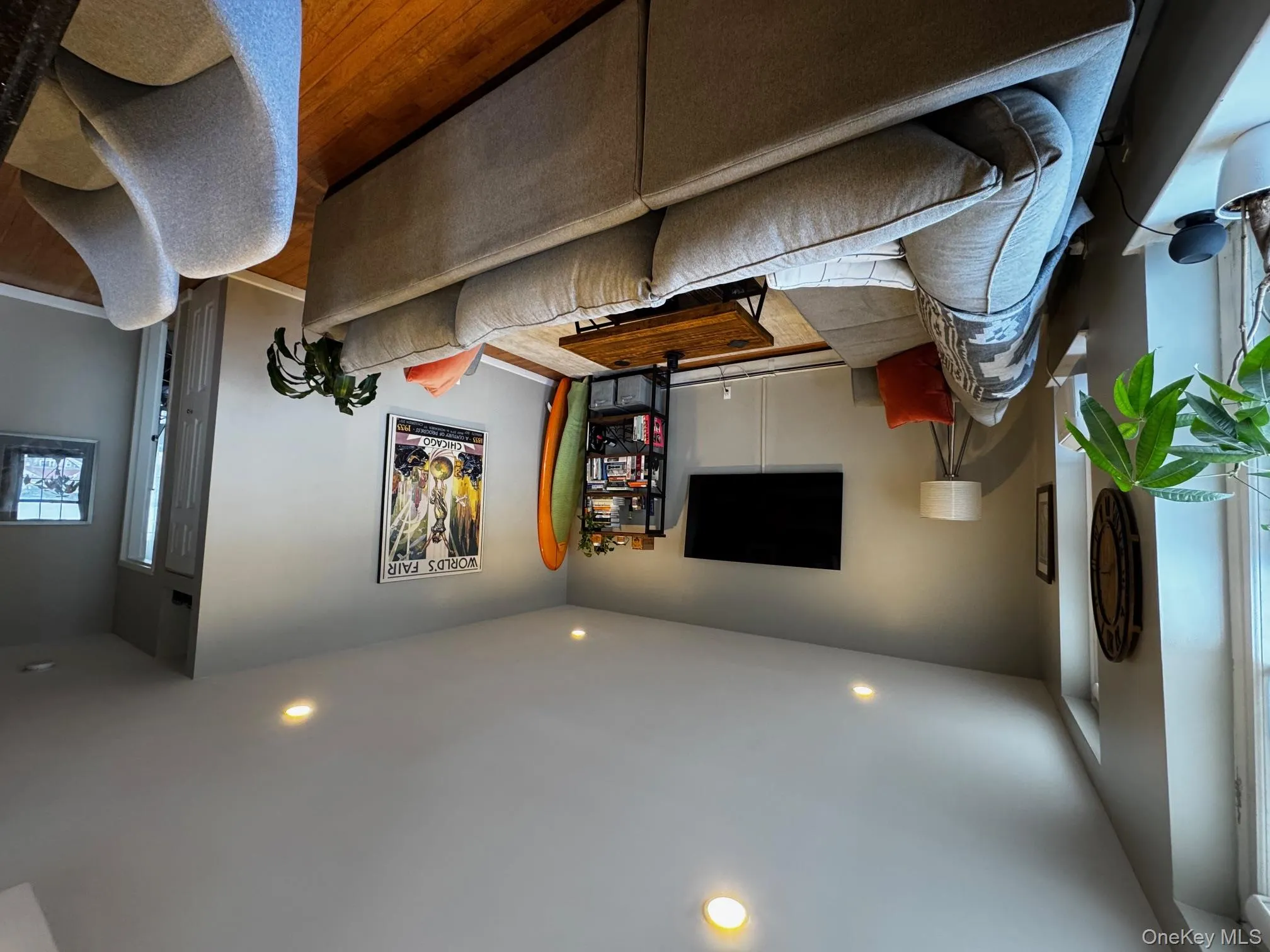 Living area featuring baseboards, a baseboard radiator, wood finished floors, and recessed lighting Living area featuring baseboards, a baseboard radiator, wood finished floors, and recessed lighting