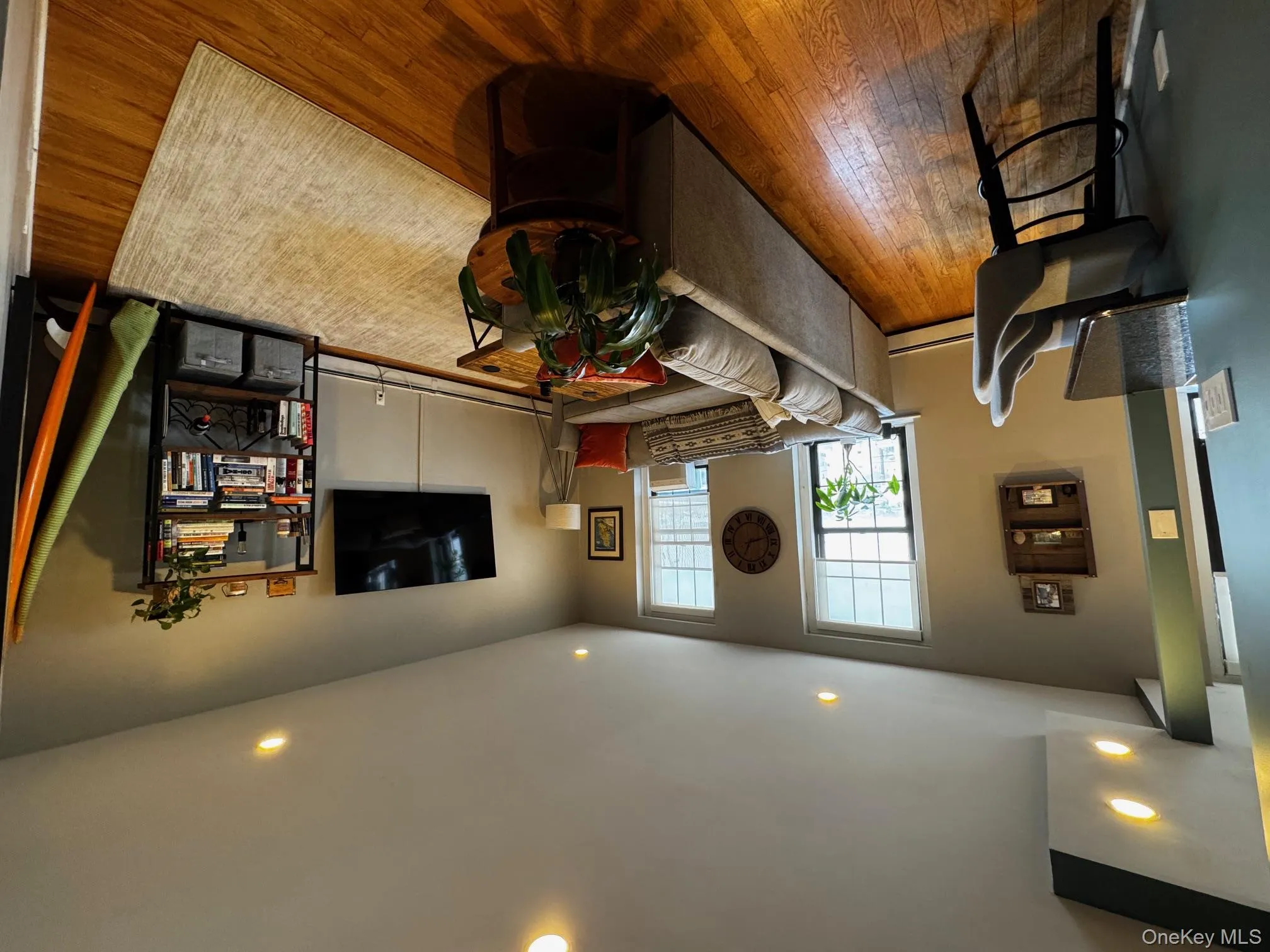 Living room with baseboard heating, wood finished floors, and recessed lighting Living room with baseboard heating, wood finished floors, and recessed lighting
