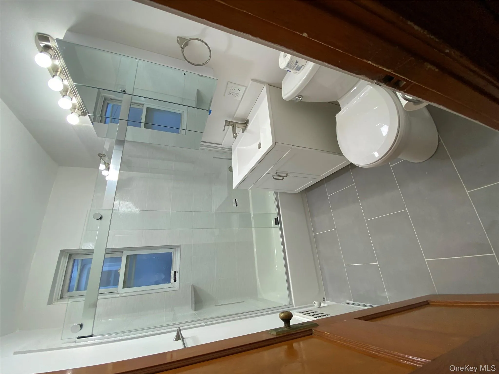 Bathroom with vanity, enclosed tub / shower combo, and tile patterned floors Bathroom with vanity, enclosed tub / shower combo, and tile patterned floors