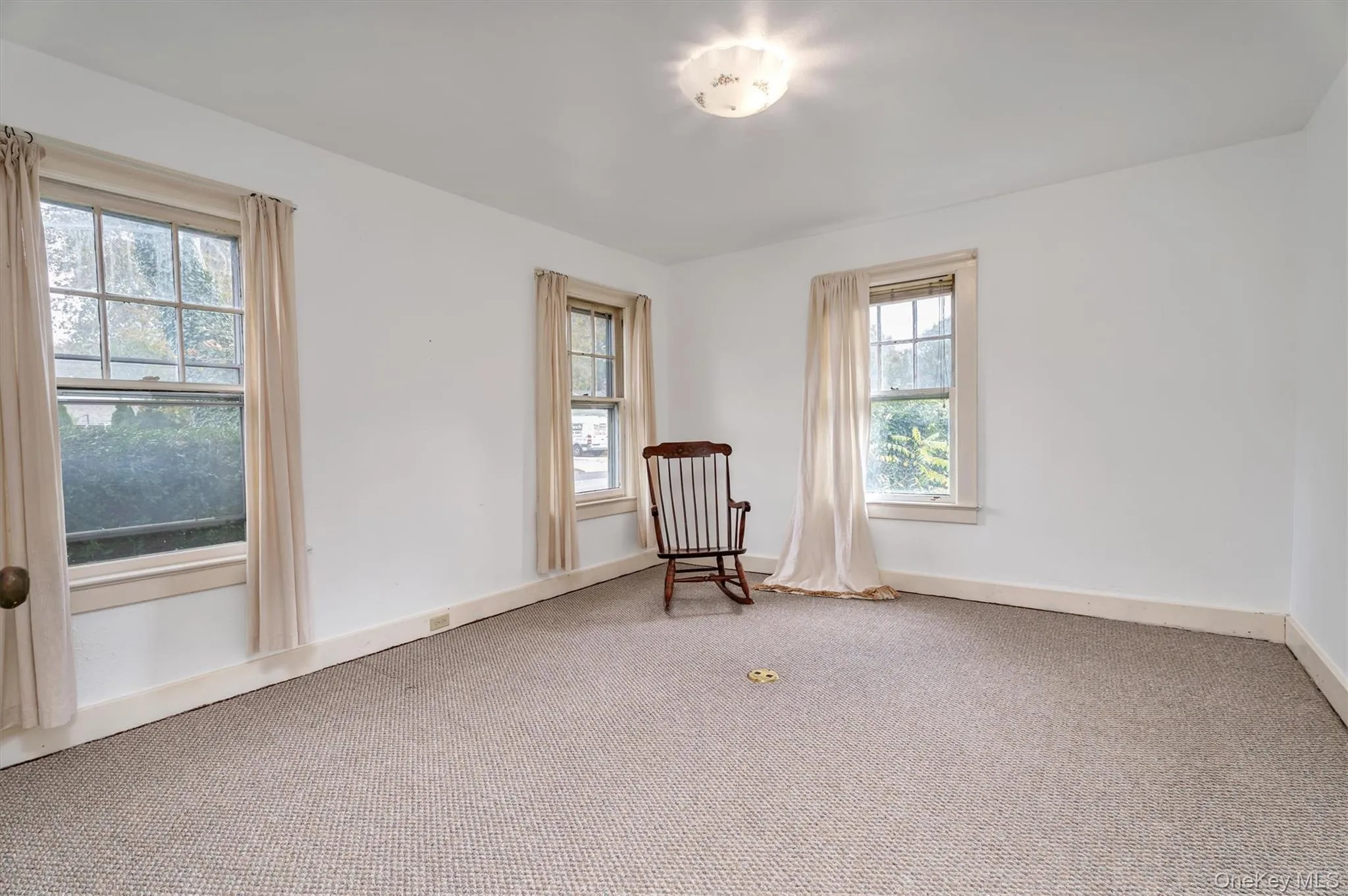 Unfurnished room with carpet floors and baseboards Unfurnished room with carpet floors and baseboards
