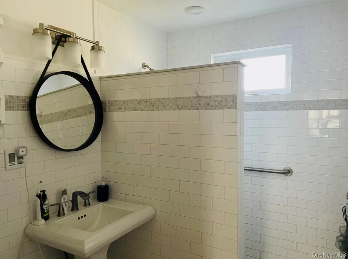 Bathroom with tile walls and a tile shower Bathroom with tile walls and a tile shower