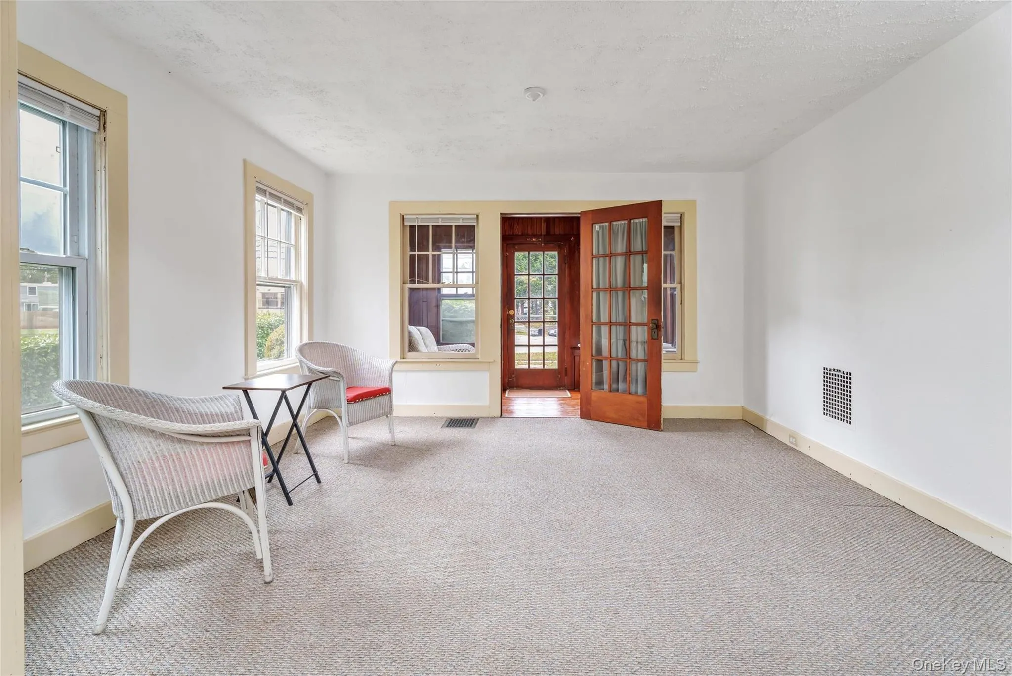 Living area with carpet floors and a textured ceiling Living area with carpet floors and a textured ceiling