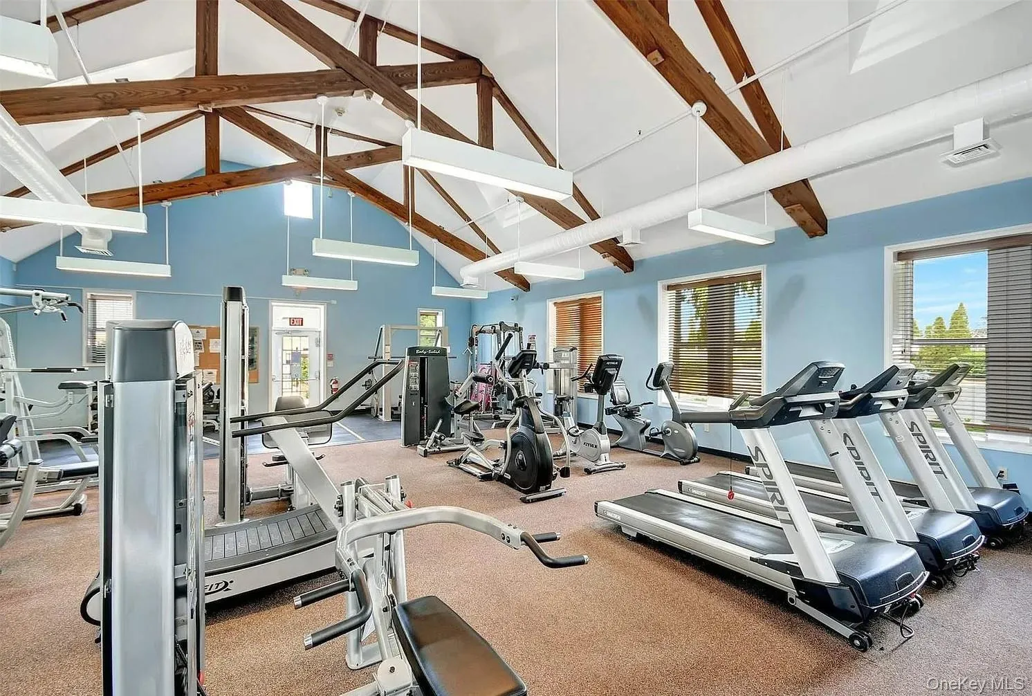 Exercise room with high vaulted ceiling and beam ceiling Exercise room with high vaulted ceiling and beam ceiling