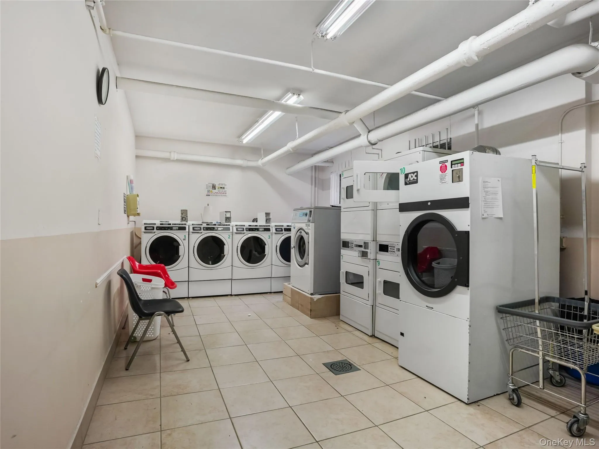 Communal laundry room featuring washing machine and clothes dryer Communal laundry room featuring washing machine and clothes dryer