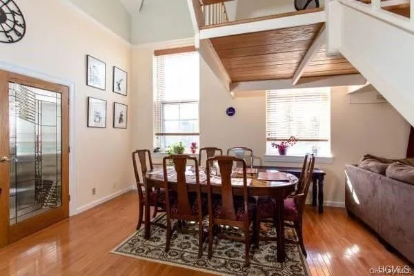 Dining space with light wood-style flooring, wooden ceiling, and plenty of natural light Dining space with light wood-style flooring, wooden ceiling, and plenty of natural light