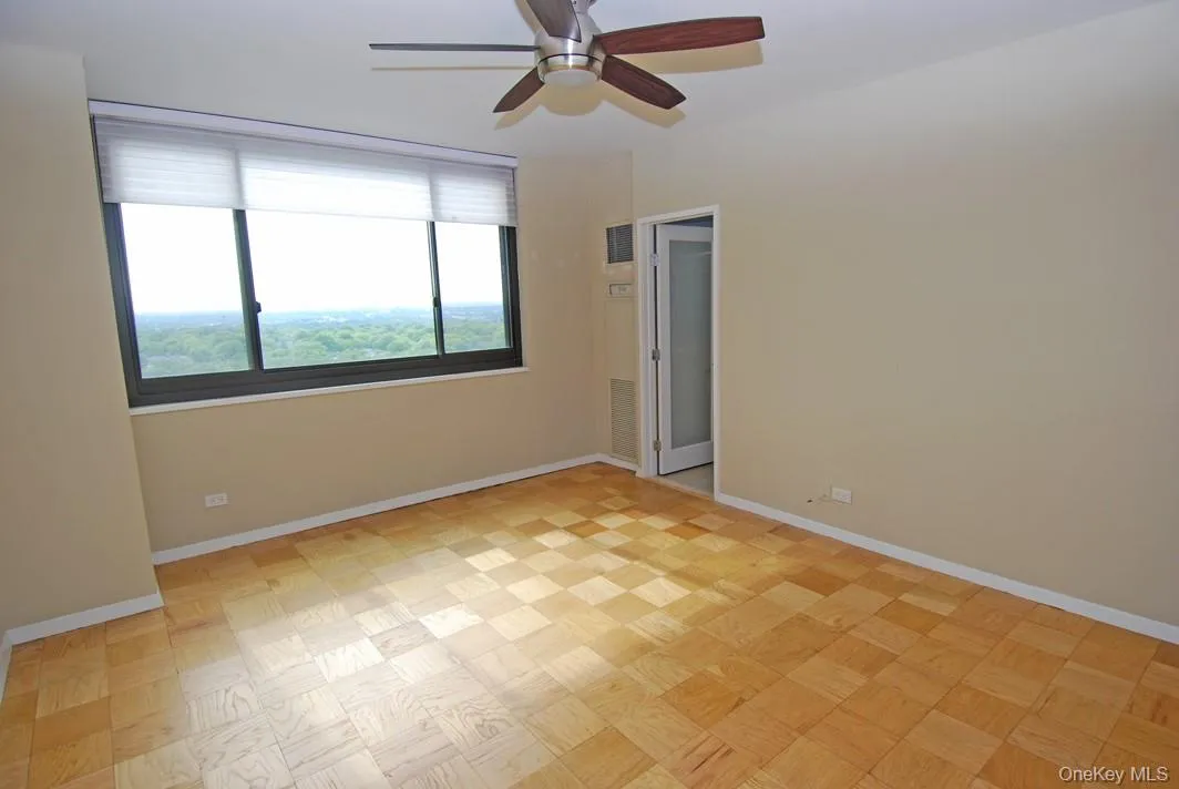 Spare room with baseboards and a ceiling fan Spare room with baseboards and a ceiling fan