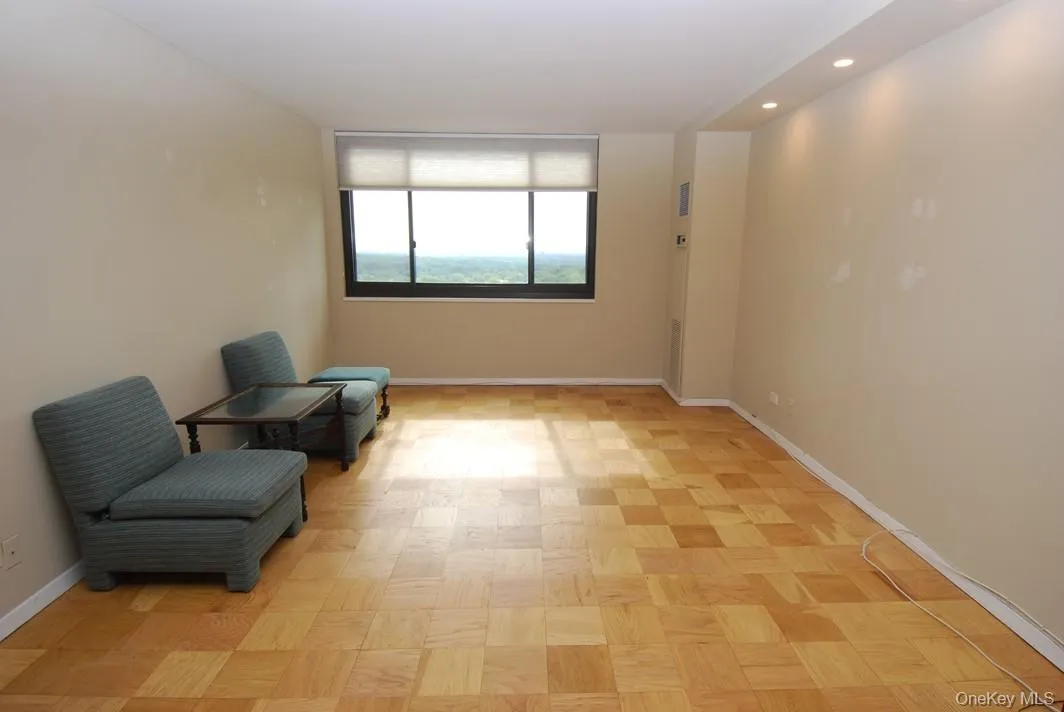 Living area featuring baseboards and recessed lighting Living area featuring baseboards and recessed lighting