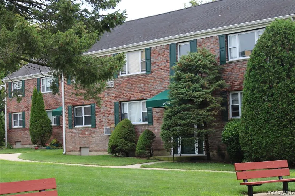 View of front of home with a front yard and brick siding View of front of home with a front yard and brick siding