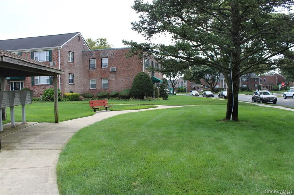 View of property's community featuring mail area, a yard, and a residential view View of property's community featuring mail area, a yard, and a residential view
