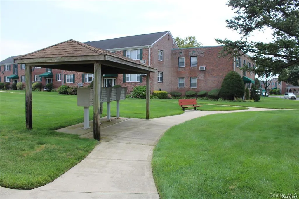 View of home's community with mail area and a lawn View of home's community with mail area and a lawn