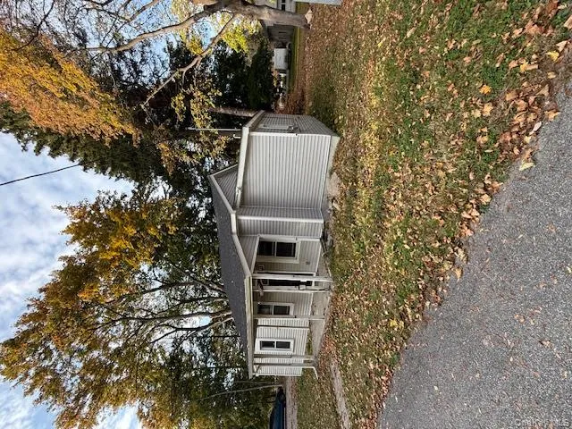 Bungalow-style house featuring covered porch, a front yard, and a shingled roof Bungalow-style house featuring covered porch, a front yard, and a shingled roof