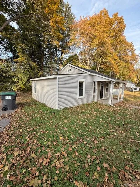 Rear view of house featuring a yard and a patio area Rear view of house featuring a yard and a patio area
