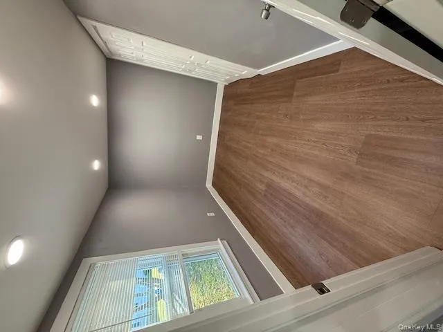 Unfurnished bedroom with wood finished floors, recessed lighting, and a closet Unfurnished bedroom with wood finished floors, recessed lighting, and a closet