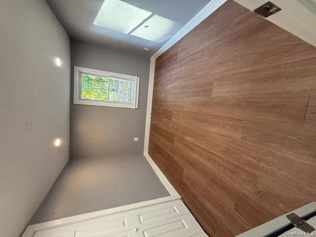Spare room featuring wood finished floors and recessed lighting Spare room featuring wood finished floors and recessed lighting