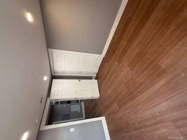 Unfurnished bedroom with recessed lighting, a closet, and wood finished floors Unfurnished bedroom with recessed lighting, a closet, and wood finished floors