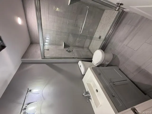 Bathroom featuring vanity and a shower stall Bathroom featuring vanity and a shower stall