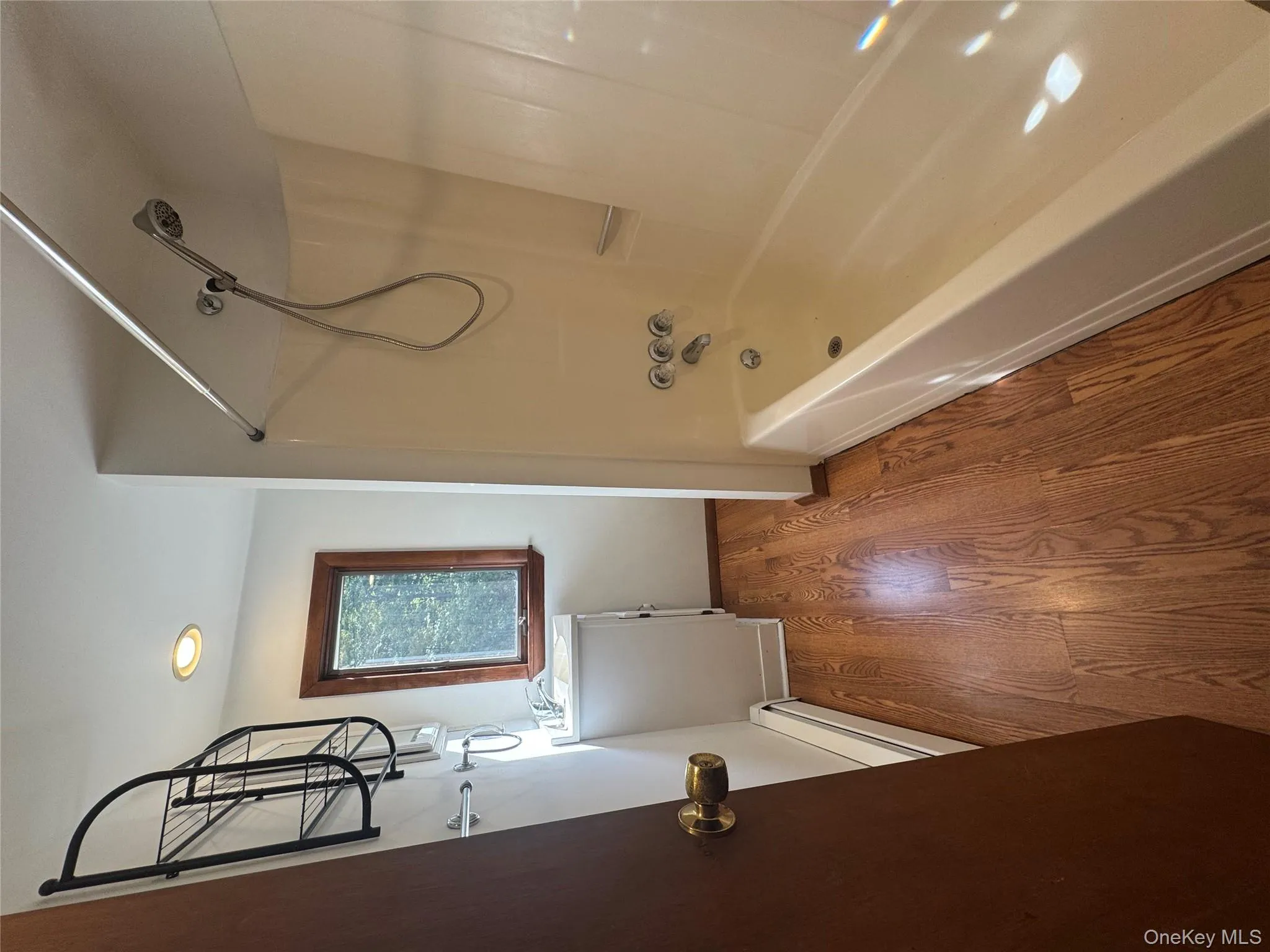 Bathroom featuring shower / tub combination, dark wood-type flooring, baseboard heating, recessed lighting, and vanity Bathroom featuring shower / tub combination, dark wood-type flooring, baseboard heating, recessed lighting, and vanity