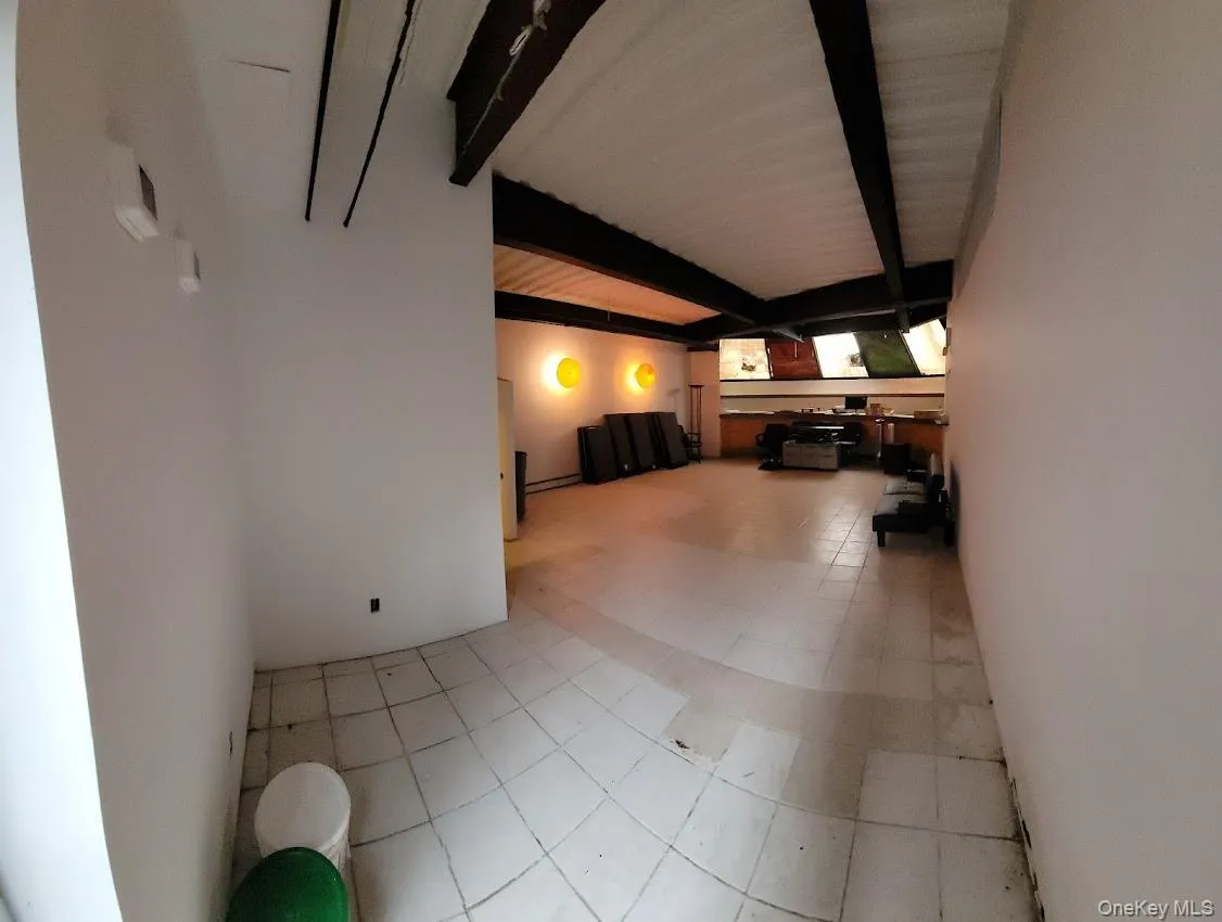 Living room featuring beam ceiling Living room featuring beam ceiling