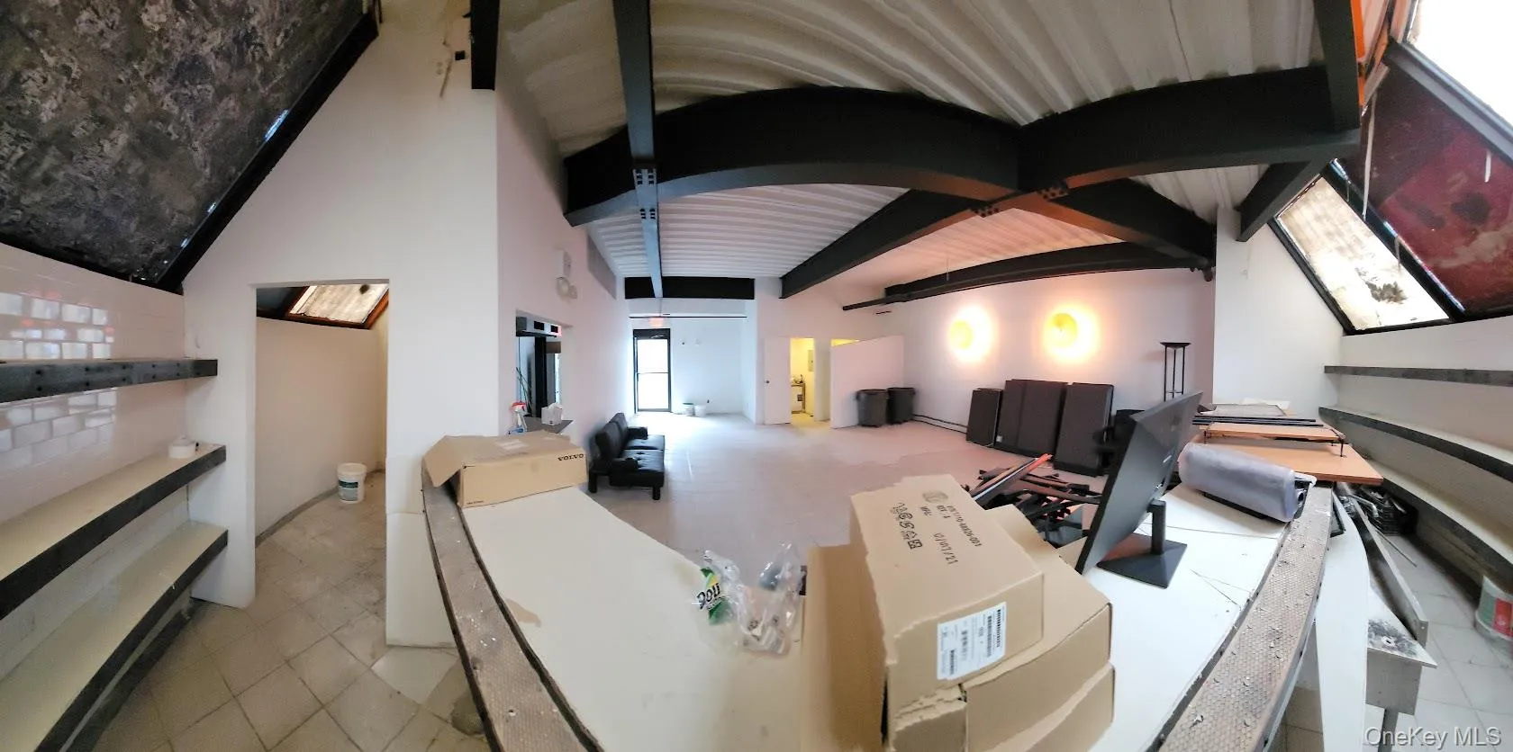 Living area with beamed ceiling and high vaulted ceiling Living area with beamed ceiling and high vaulted ceiling