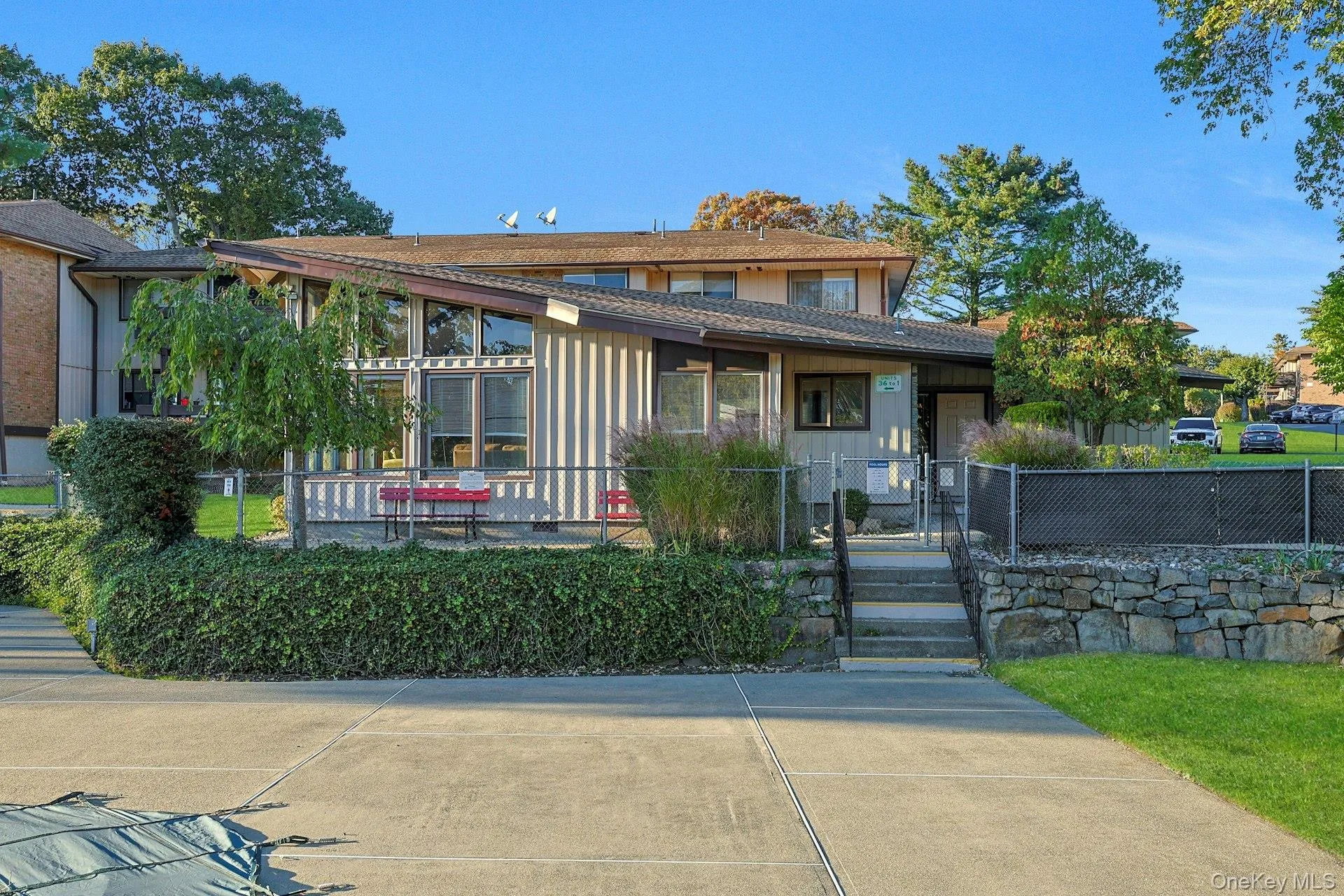 View of front of home with a fenced front yard, a gate, and board and batten siding View of front of home with a fenced front yard, a gate, and board and batten siding