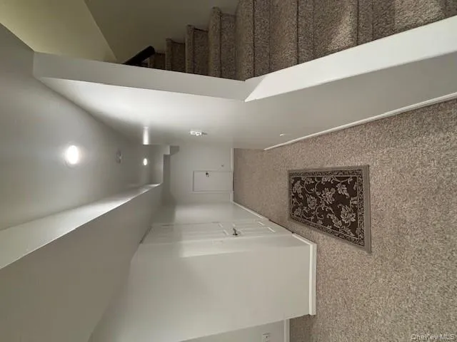Finished basement featuring carpet floors and stairway Finished basement featuring carpet floors and stairway