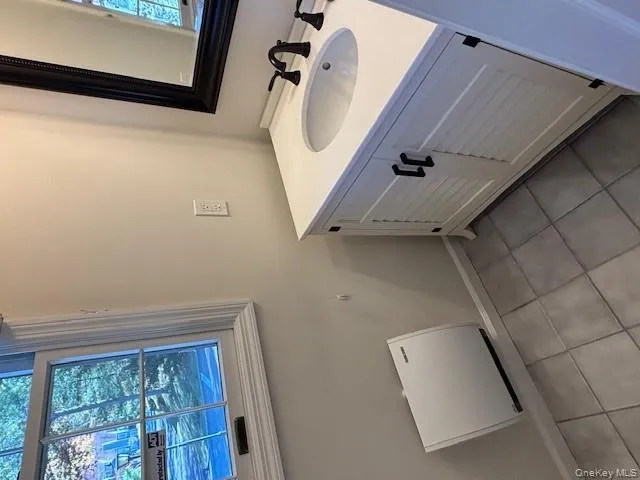 Bathroom with vanity and light tile patterned flooring Bathroom with vanity and light tile patterned flooring