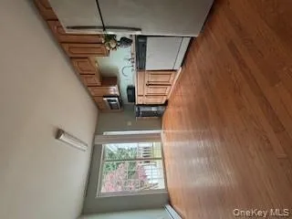 Kitchen featuring fridge, dark wood-style flooring, dishwashing machine, and black range Kitchen featuring fridge, dark wood-style flooring, dishwashing machine, and black range