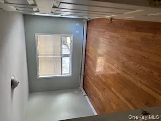 Unfurnished bedroom featuring dark wood finished floors and a baseboard heating unit Unfurnished bedroom featuring dark wood finished floors and a baseboard heating unit