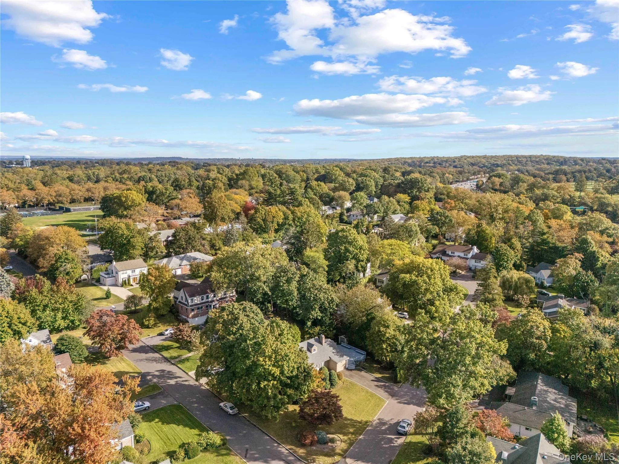 View of property location featuring nearby suburban area and a forest View of property location featuring nearby suburban area and a forest