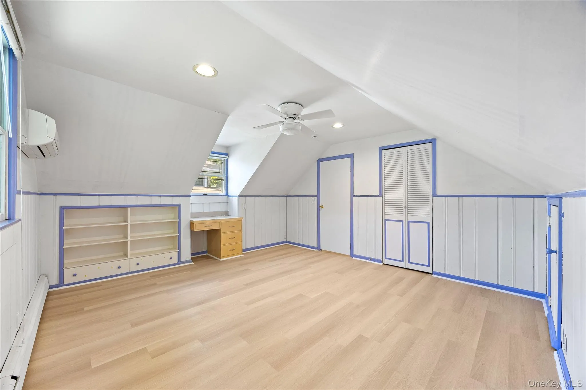 Bonus room with lofted ceiling, a baseboard radiator, light wood-style flooring, recessed lighting, and a wall mounted air conditioner Bonus room with lofted ceiling, a baseboard radiator, light wood-style flooring, recessed lighting, and a wall mounted air conditioner