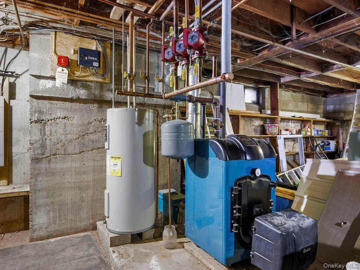 Utilities featuring water heater and a heating unit Utilities featuring water heater and a heating unit