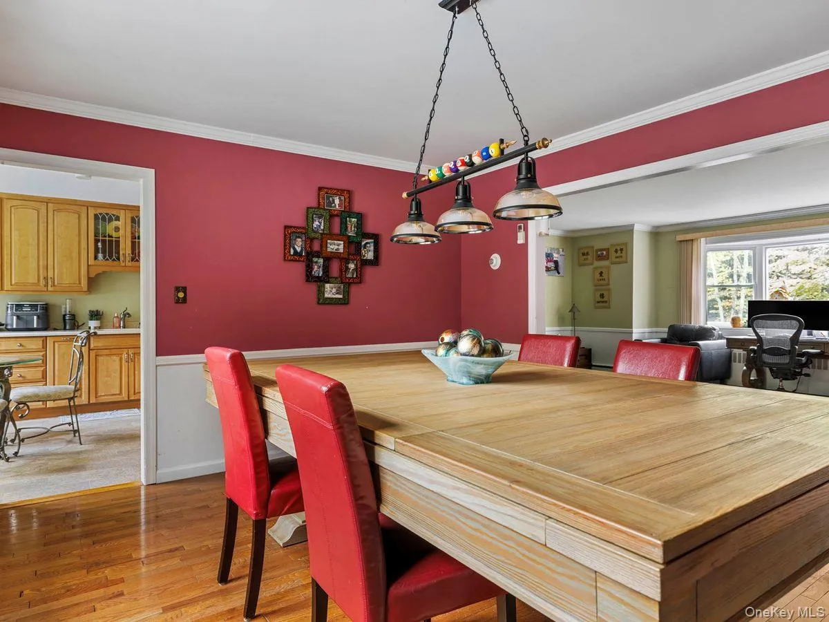 Dining space featuring light wood finished floors and ornamental molding Dining space featuring light wood finished floors and ornamental molding