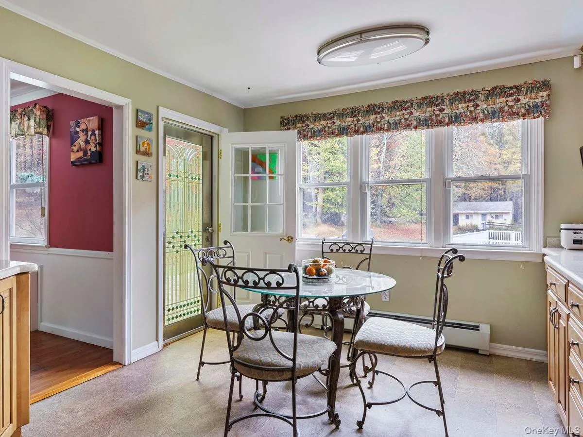 Dining room featuring healthy amount of natural light and ornamental molding Dining room featuring healthy amount of natural light and ornamental molding
