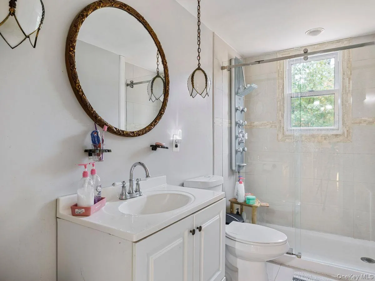 Full bath featuring vanity and a shower stall Full bath featuring vanity and a shower stall
