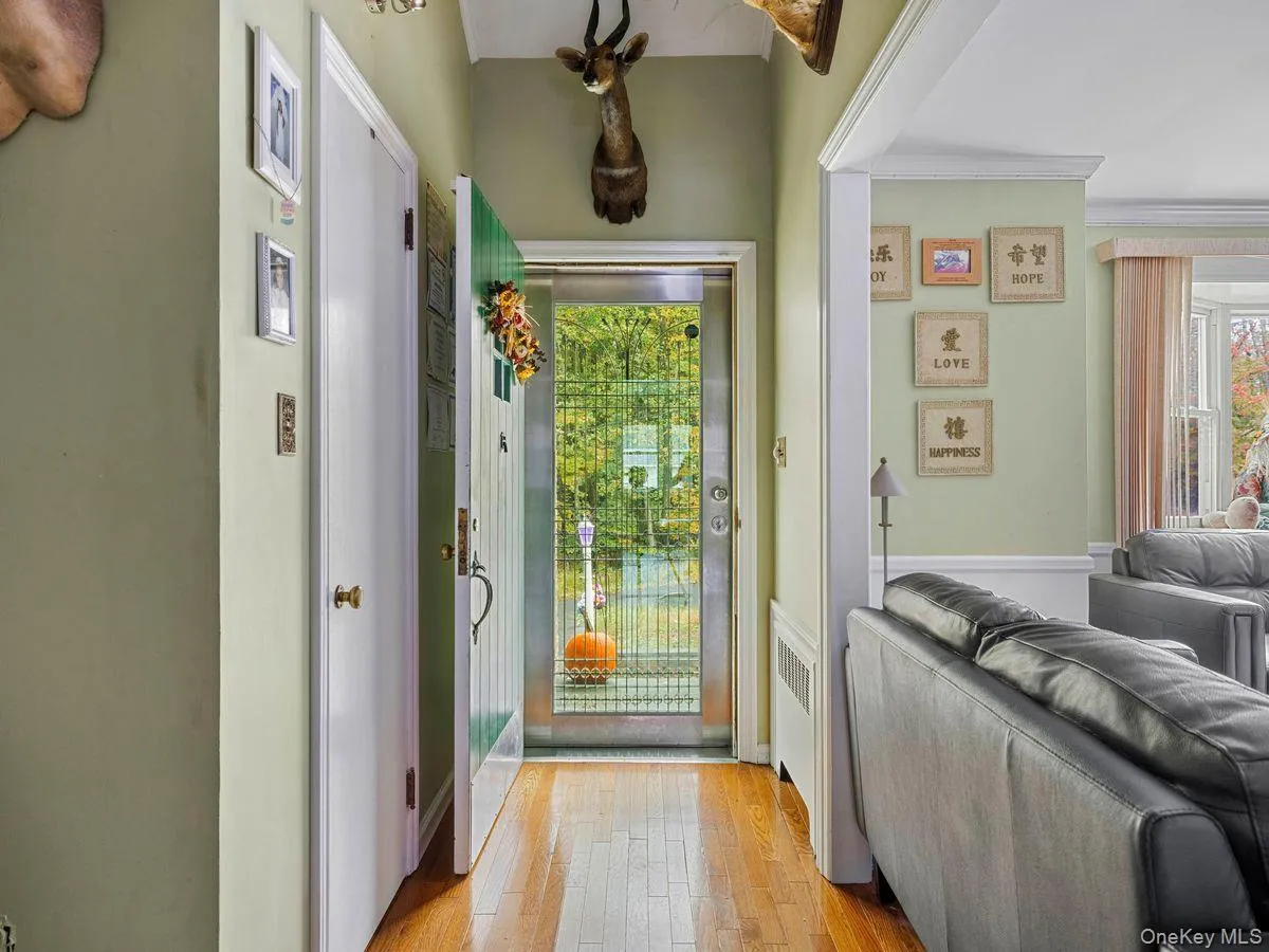 Doorway featuring hardwood / wood-style floors and radiator heating unit Doorway featuring hardwood / wood-style floors and radiator heating unit