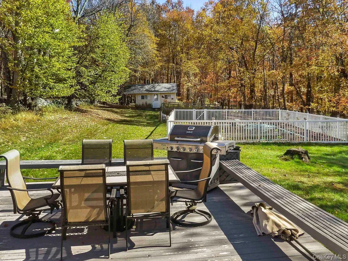 Deck featuring outdoor dining area and a grill Deck featuring outdoor dining area and a grill
