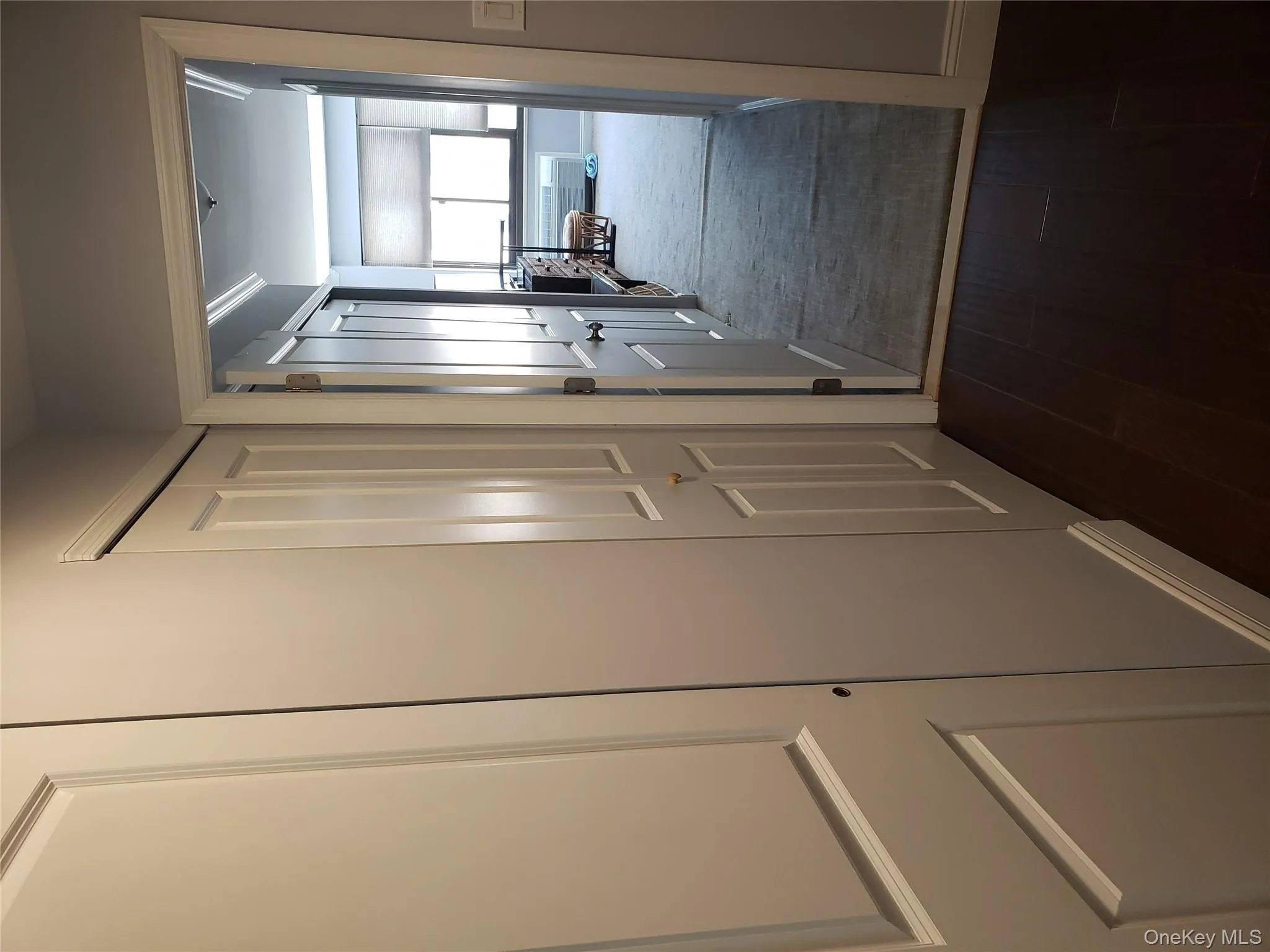 Corridor featuring baseboards and dark wood-style flooring Corridor featuring baseboards and dark wood-style flooring