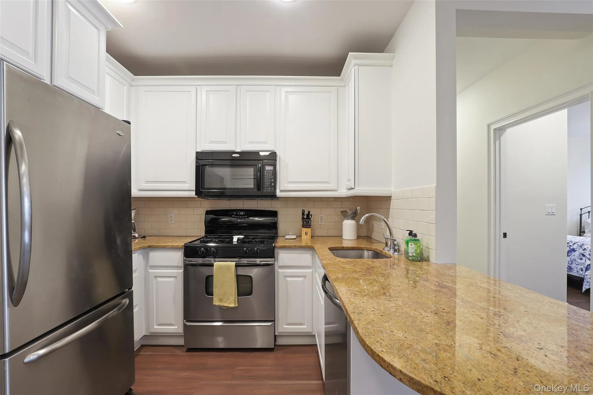 Kitchen with white cabinets, and appliances with stainless steel finishes Kitchen with white cabinets, and appliances with stainless steel finishes
