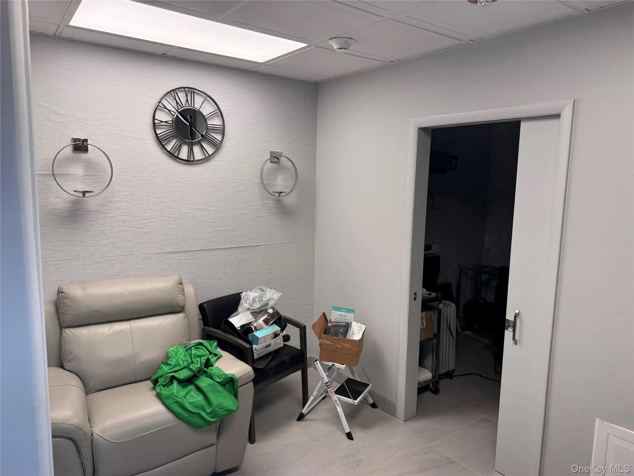 Living area with light tile patterned floors and baseboards Living area with light tile patterned floors and baseboards