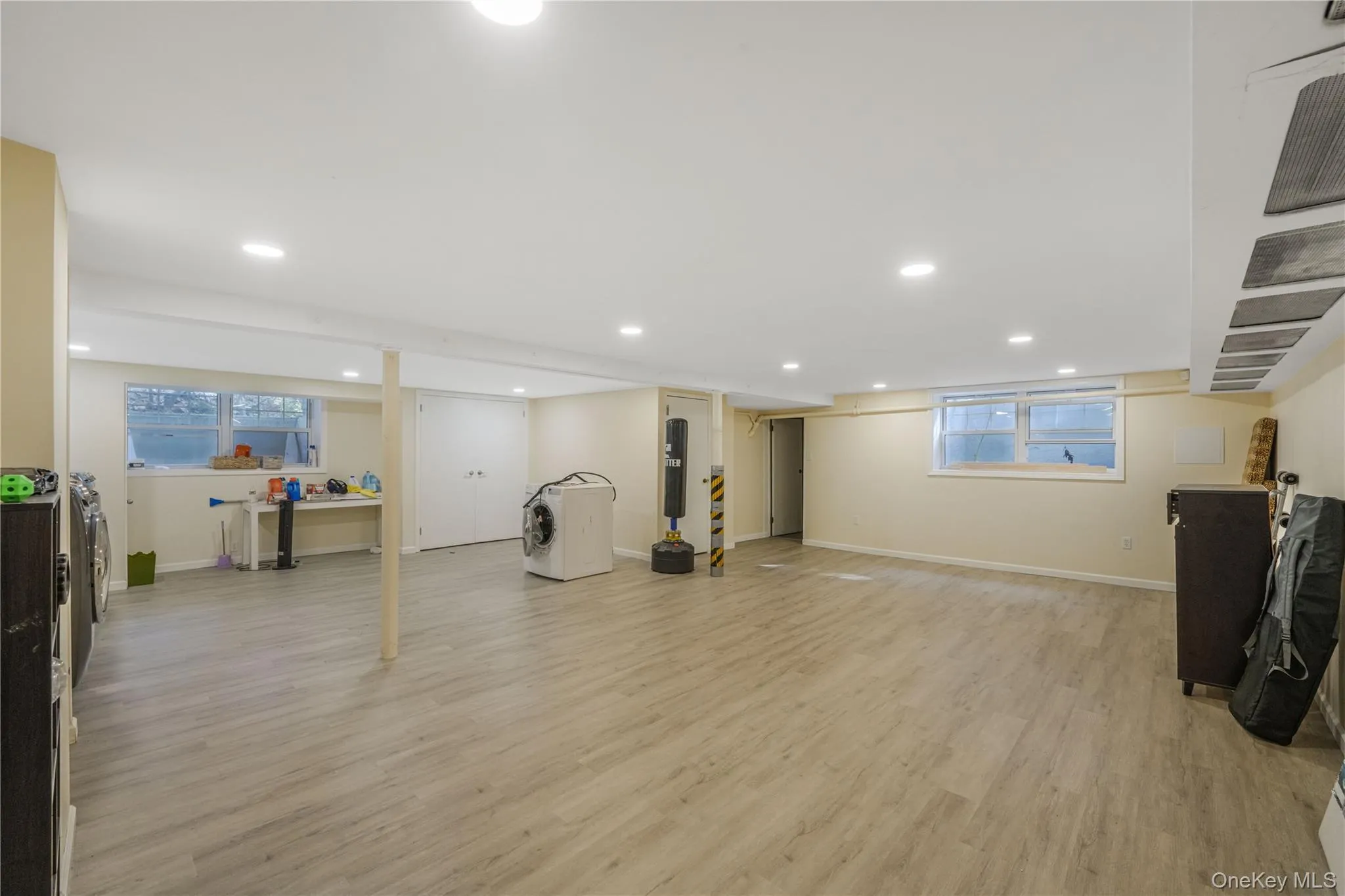 Workout room with light wood finished floors, recessed lighting, plenty of natural light, and washer / dryer Workout room with light wood finished floors, recessed lighting, plenty of natural light, and washer / dryer